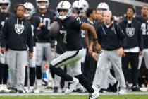 Raiders quarterback Geno Smith (7) runs with the ball for a first down during an NFL football g ...