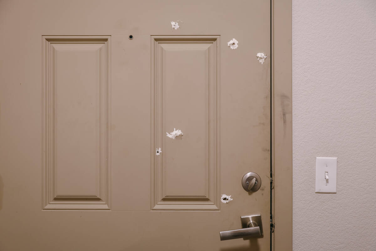 Spackled bullet holes riddle the door of Dionte Tarlini’s sister’s apartment on Friday, Oct ...