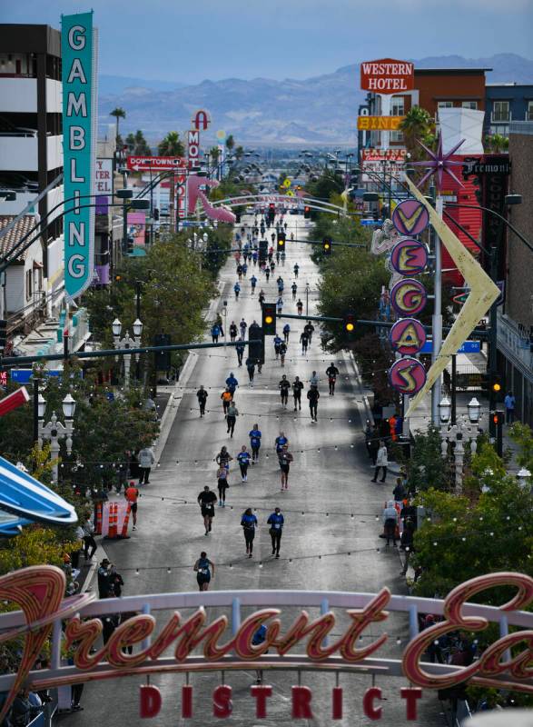 Participants head towards the finish line on Fremont Street during the 2024 Las Vegas Marathon. ...