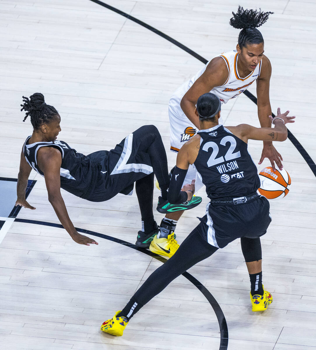 Phoenix Mercury forward Alyssa Thomas (25) charges Aces guard Jewell Loyd (24) for a foul with ...