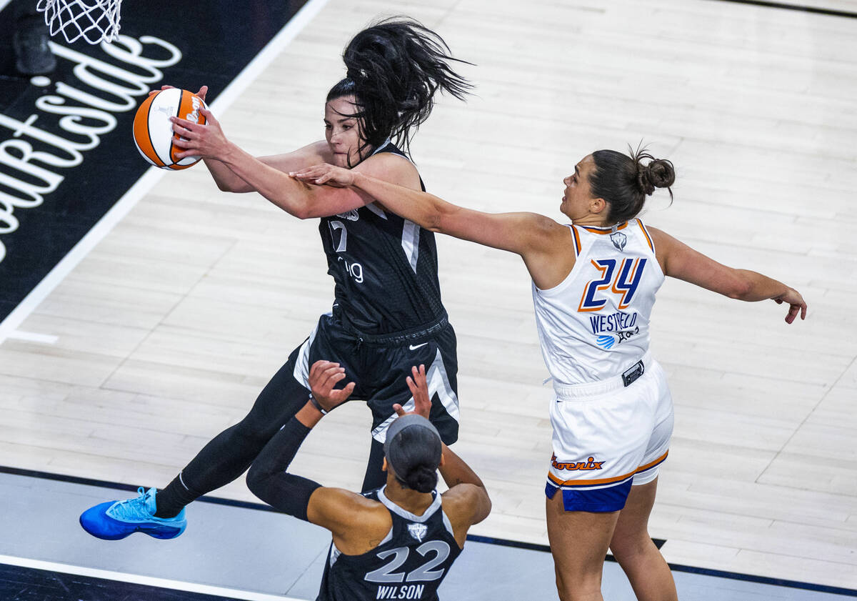 Aces center Megan Gustafson (17) secures a rebound as Phoenix Mercury forward Kathryn Westbeld ...