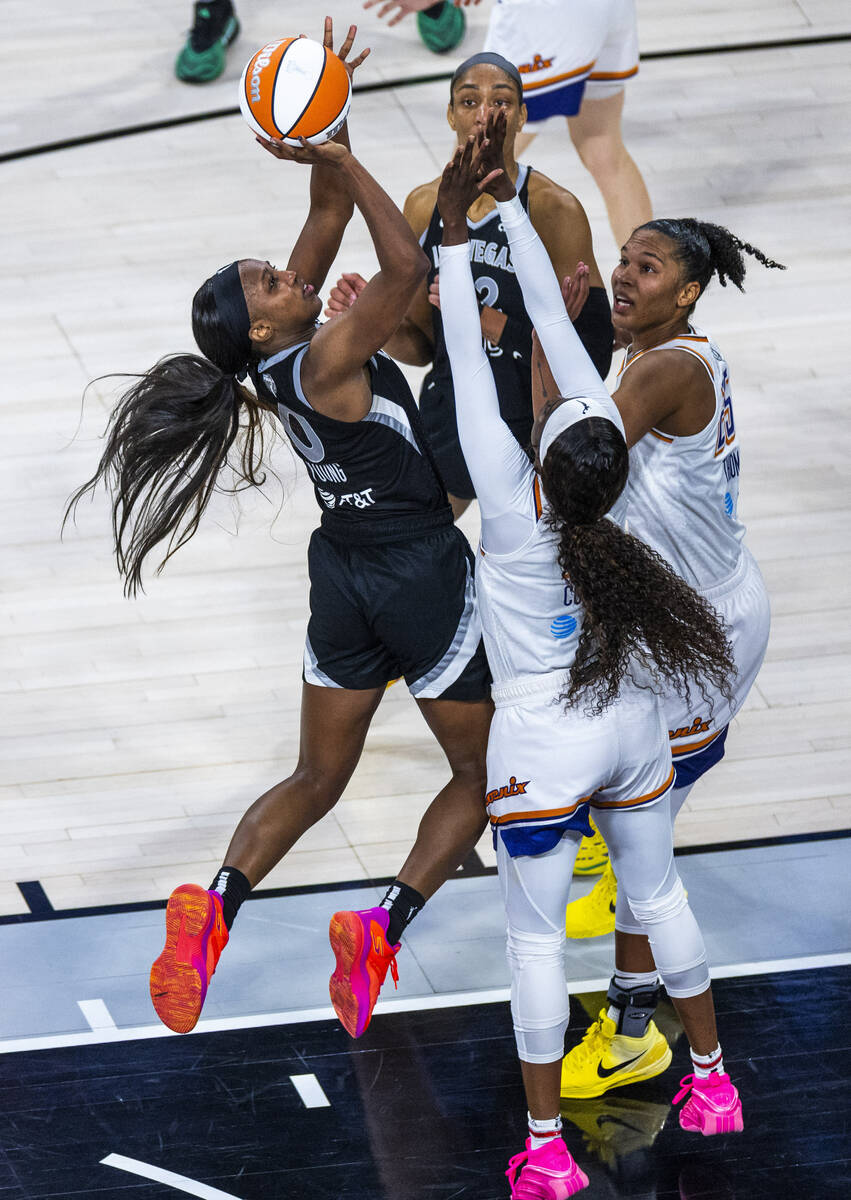 Aces guard Jackie Young (0) posts up for a basket over Phoenix Mercury forward Alyssa Thomas (2 ...
