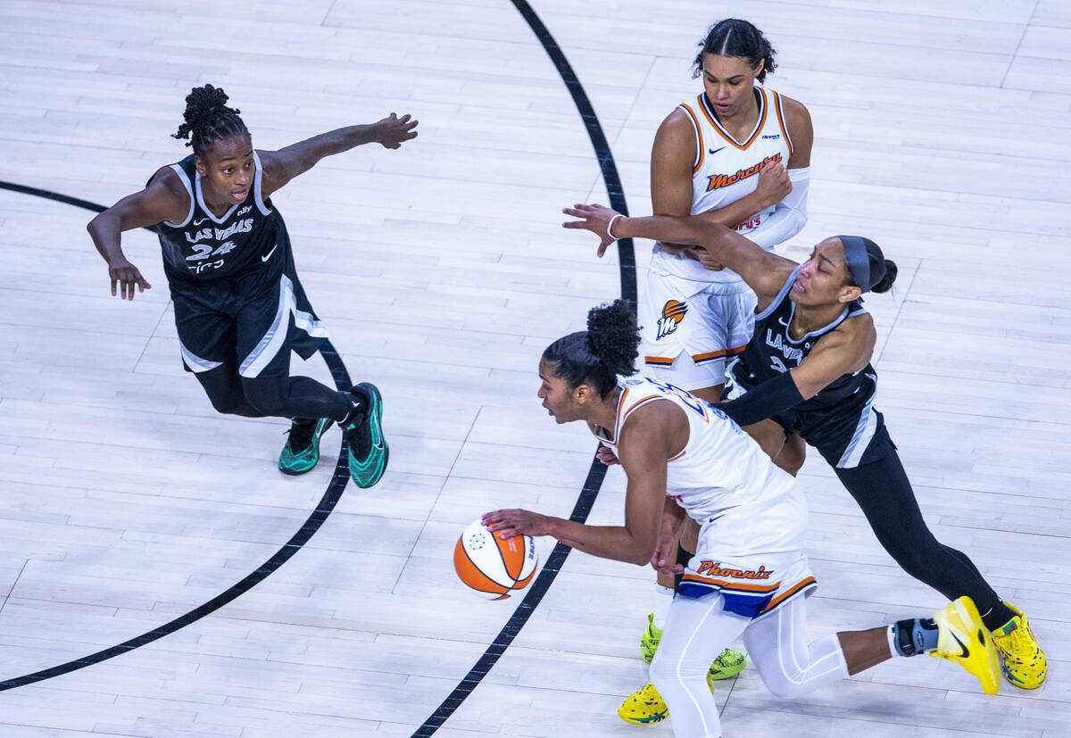 Aces guard Jewell Loyd (24) looks to guard Phoenix Mercury forward Alyssa Thomas (25) as Aces c ...