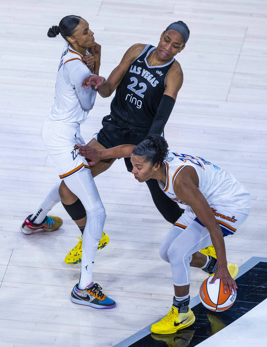 Phoenix Mercury forward DeWanna Bonner (14) seta a pick on Aces center A'ja Wilson (22) as ...
