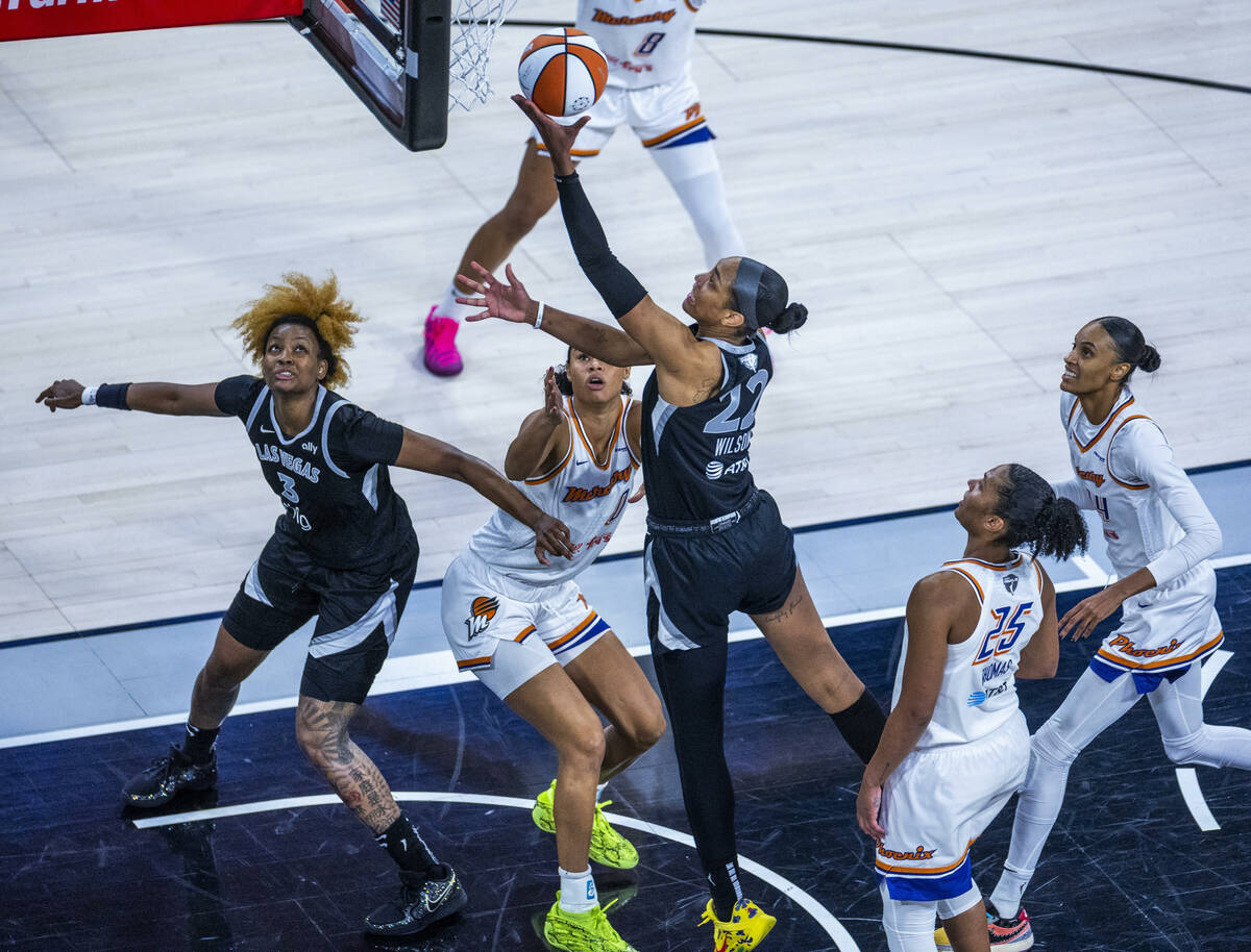 Aces center A'ja Wilson (22) elevates to the basket over Phoenix Mercury forward Satou Sab ...