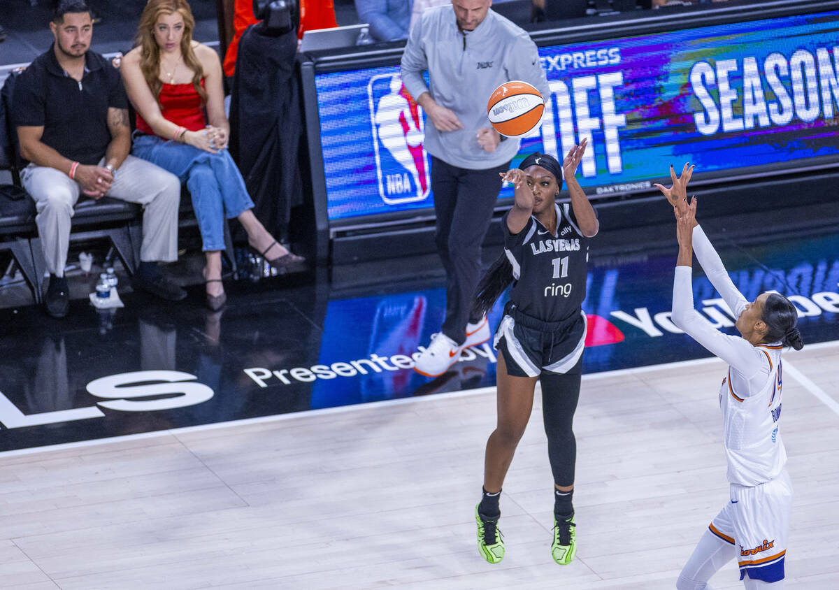 Aces guard Dana Evans (11) elevates for another three-point basket over Phoenix Mercury forward ...
