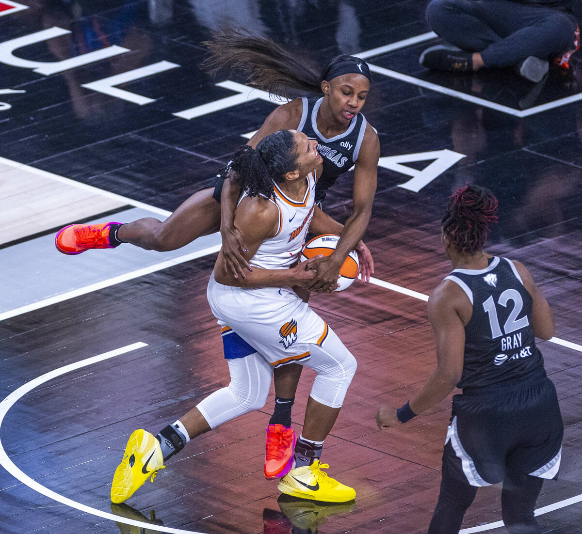 Phoenix Mercury forward Alyssa Thomas (25) crashes into Aces guard Jackie Young (0) while drivi ...