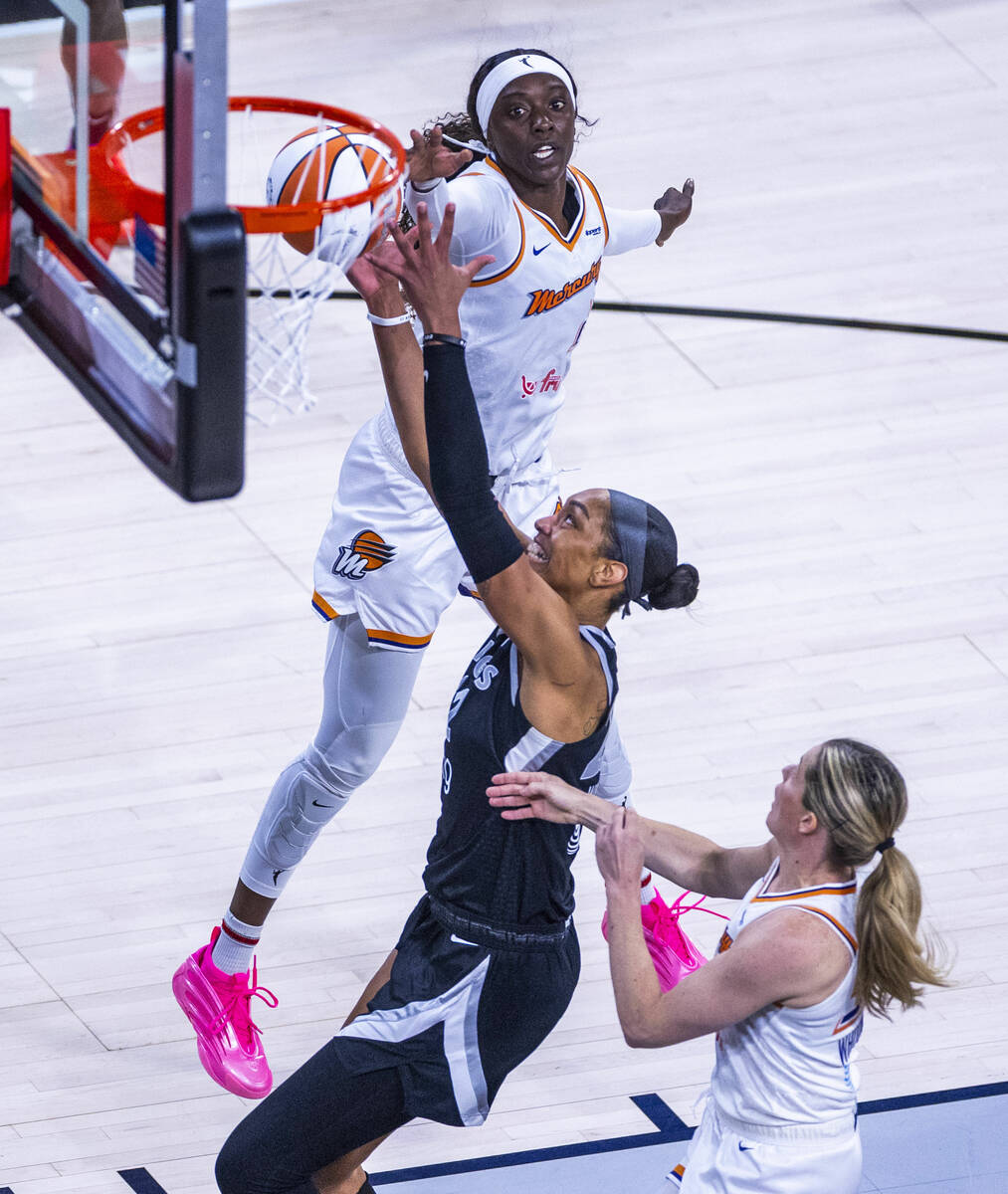 Aces center A'ja Wilson (22) attempts to grab a loose ball between Phoenix Mercury guard K ...