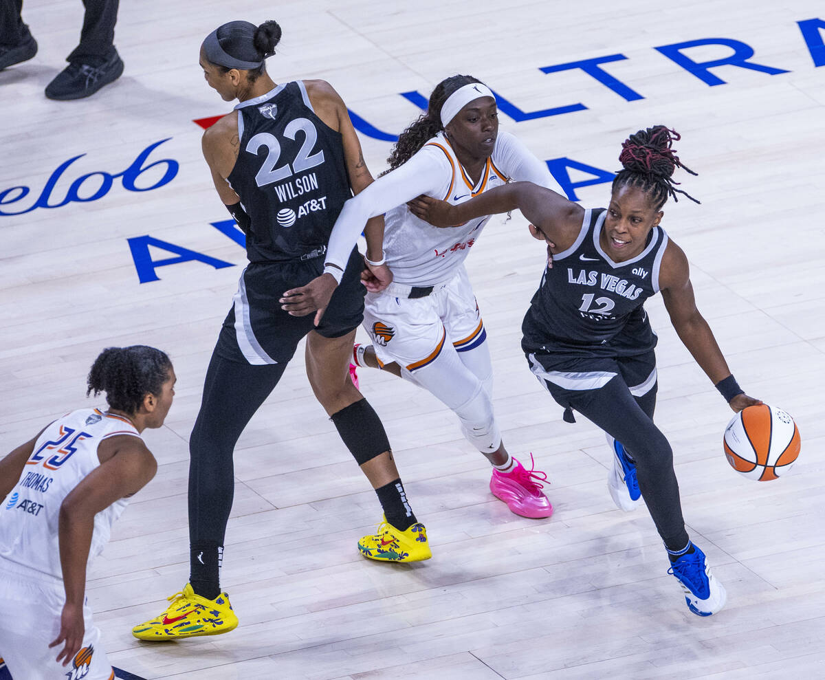 Aces guard Chelsea Gray (12) pushes past Phoenix Mercury guard Kahleah Copper (2) with a pick s ...