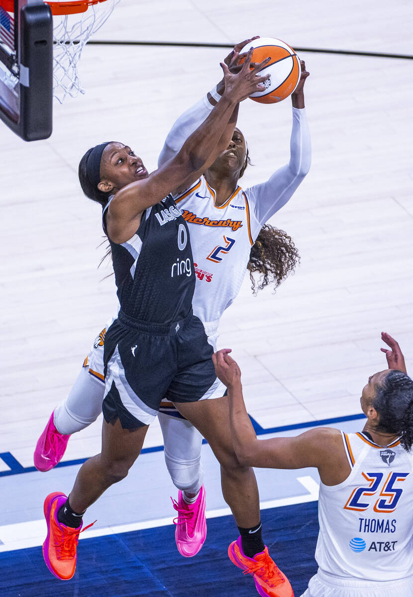Aces guard Jackie Young (0) and Phoenix Mercury guard Kahleah Copper (2) battle for a loose bal ...