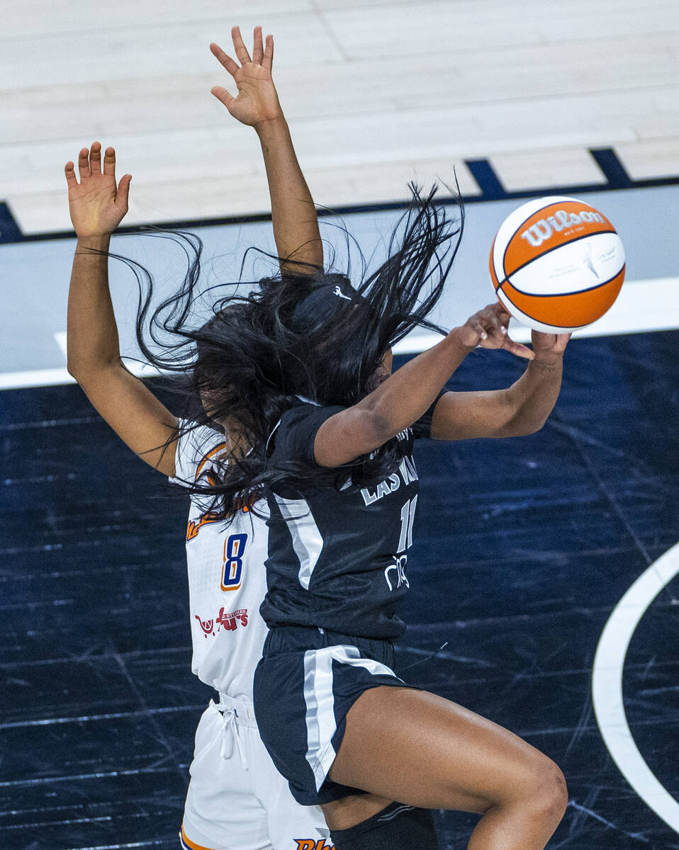 Aces guard Dana Evans (11) has her hair tangled up with Phoenix Mercury guard Monique Akoa Maka ...