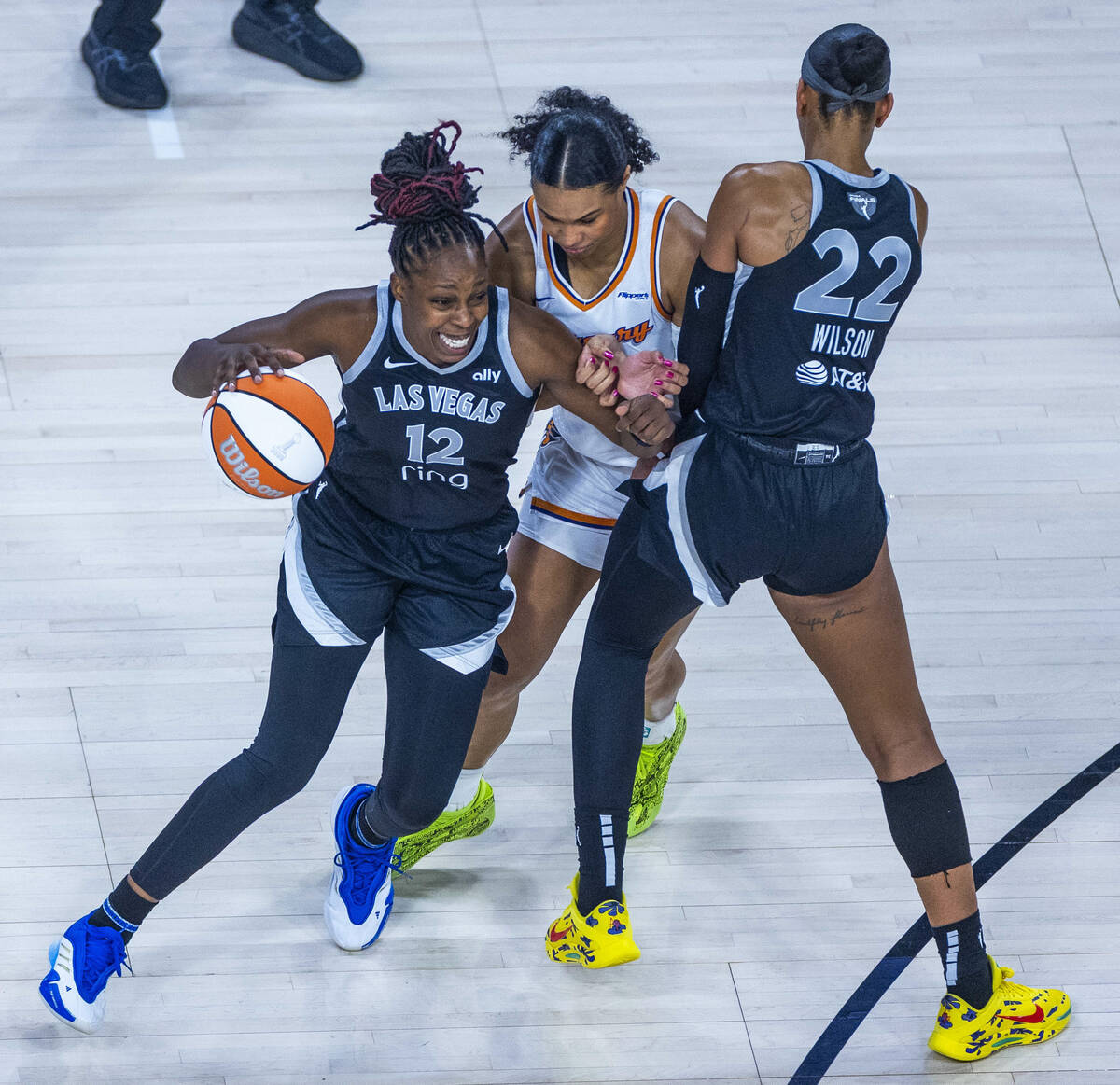 Aces guard Chelsea Gray (12) gets past Phoenix Mercury forward Satou Sabally (0) while picked ...