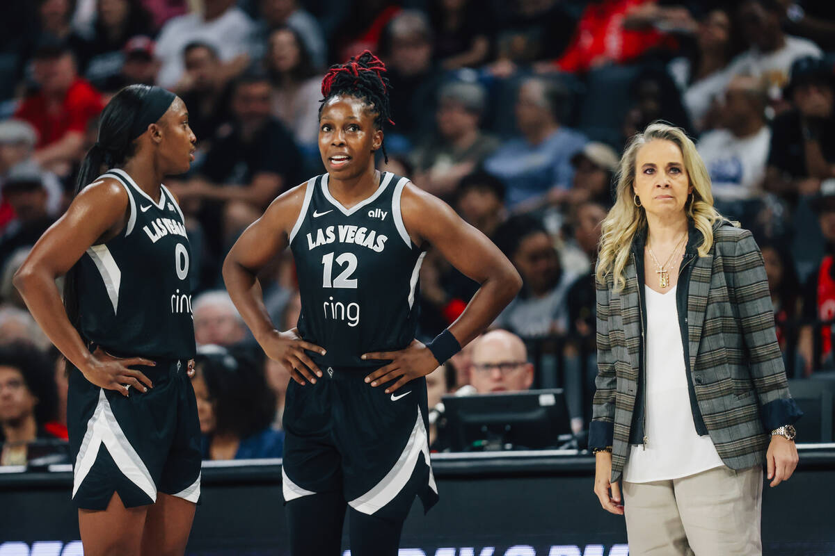 Aces guard Jackie Young (0) and guard Chelsea Gray (12) talk during a free throw next to head c ...
