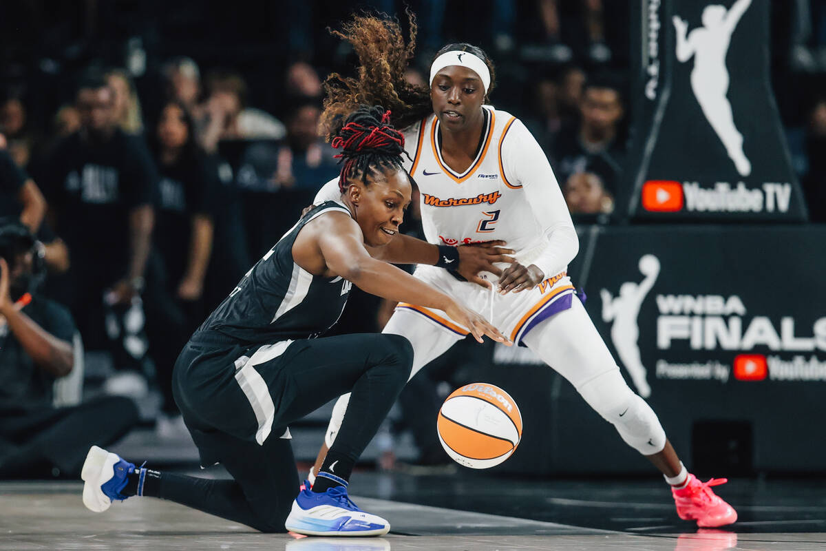 Aces guard Chelsea Gray (12) gets low to keep the ball in her possession as Phoenix Mercury gua ...