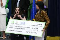 School librarian Claire Yates reacts as she receives a $50,000 donation for her library during ...