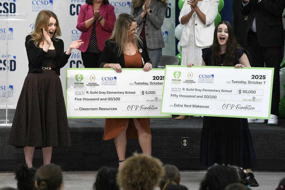 Margaret Frank, left, and Gray Elementary School principal Ashley Gannon react as librarian Cla ...