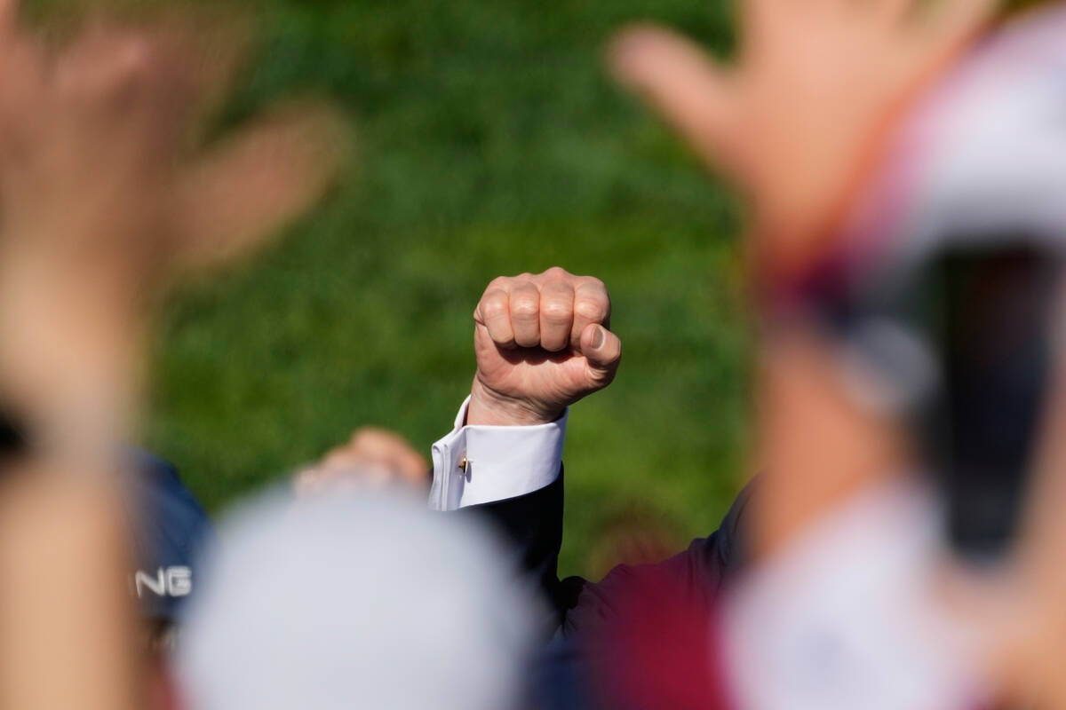 President Donald Trump pumps his fist as he greets the crowd at the Ryder Cup golf tournament, ...