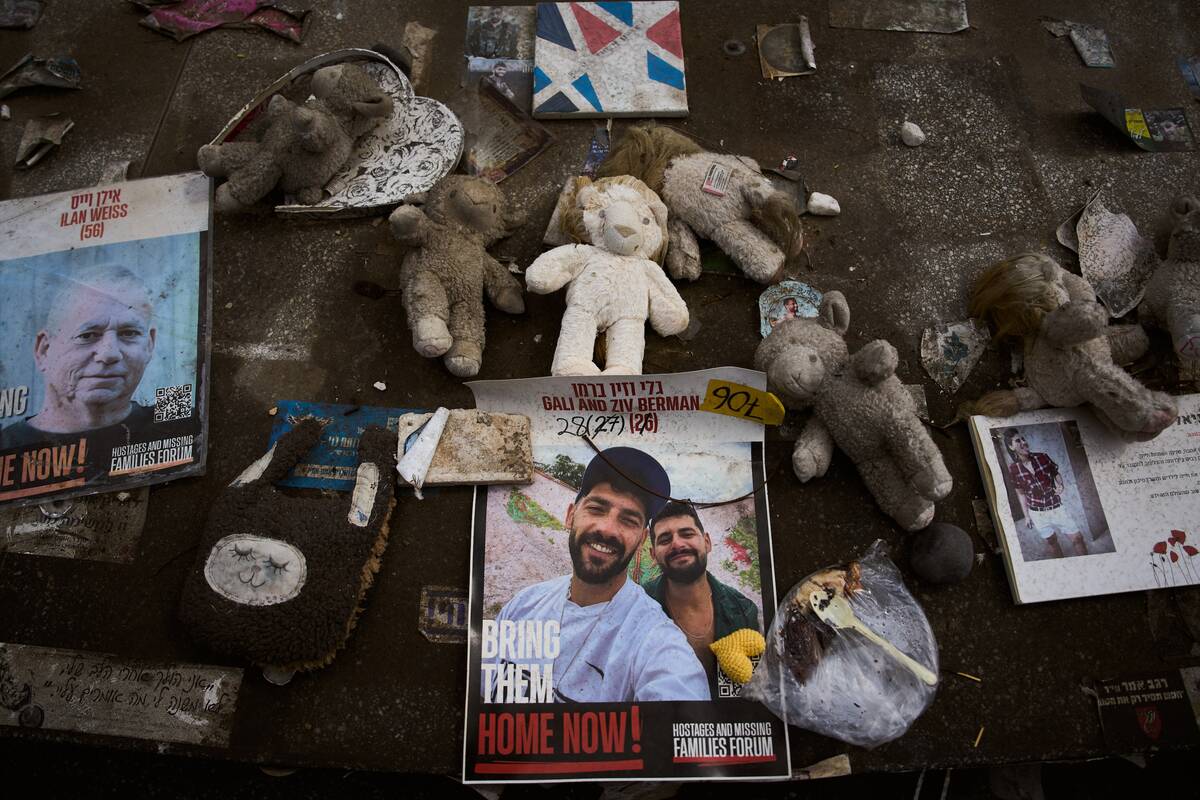 Photos of twin brothers Gali and Ziv Berman, center, who have been held hostage in Gaza since t ...