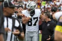 Raiders tight end Michael Mayer (87) comes off of the field with the help of trainers after suf ...