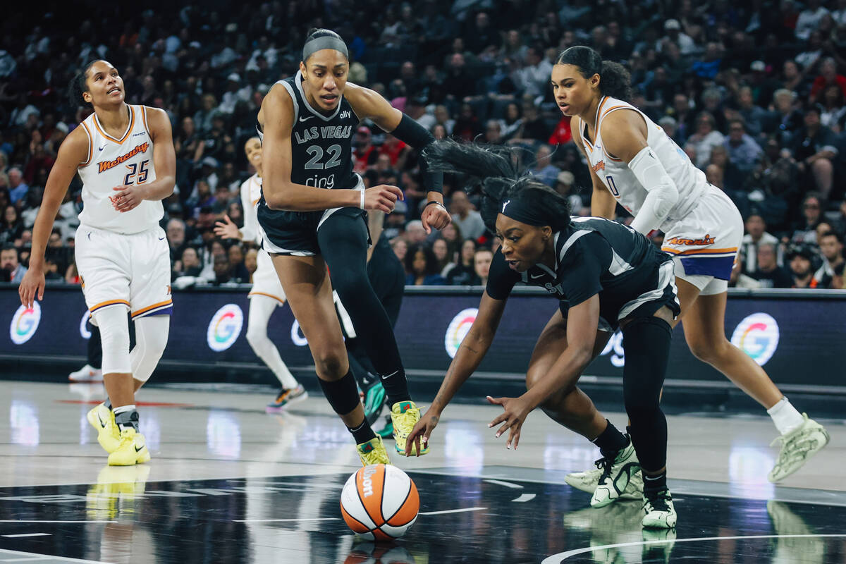 Aces guard Dana Evans (11) dives for a loose ball during game one of a WNBA finals basketball g ...
