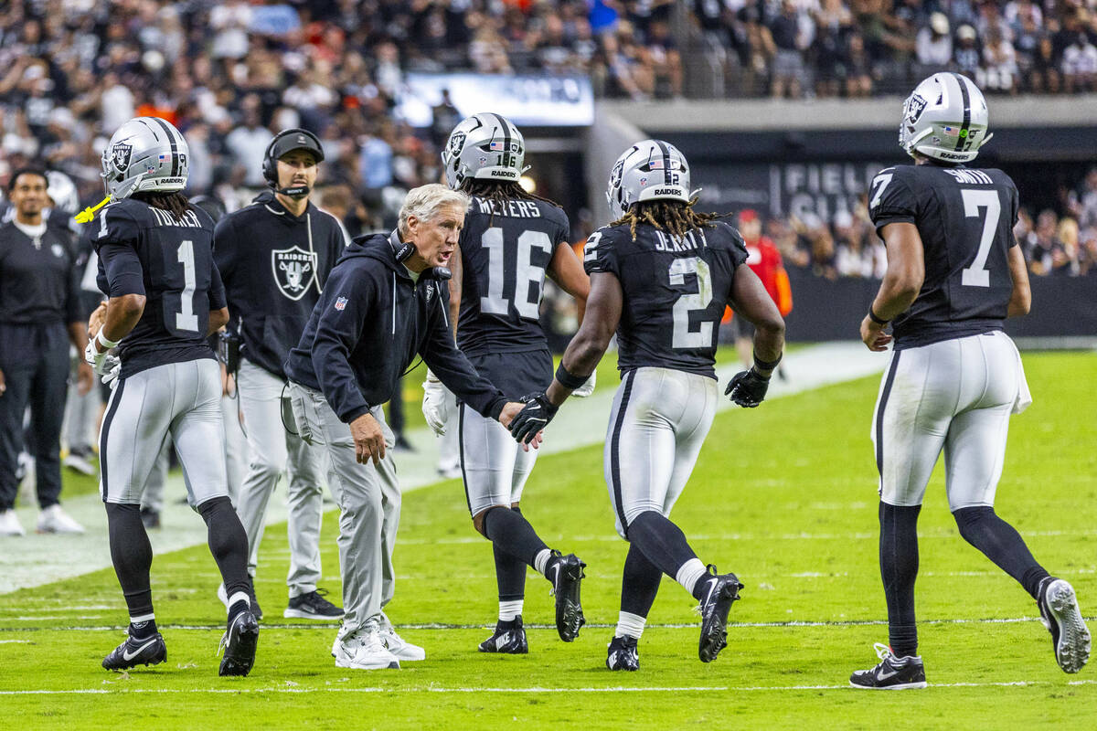 Raiders head coach Pete Carroll congratulates running back Ashton Jeanty (2) on a touchdown run ...