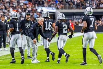 Raiders head coach Pete Carroll congratulates running back Ashton Jeanty (2) on a touchdown run ...
