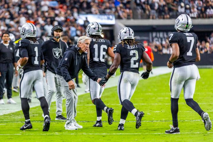 Raiders head coach Pete Carroll congratulates running back Ashton Jeanty (2) on a touchdown run ...