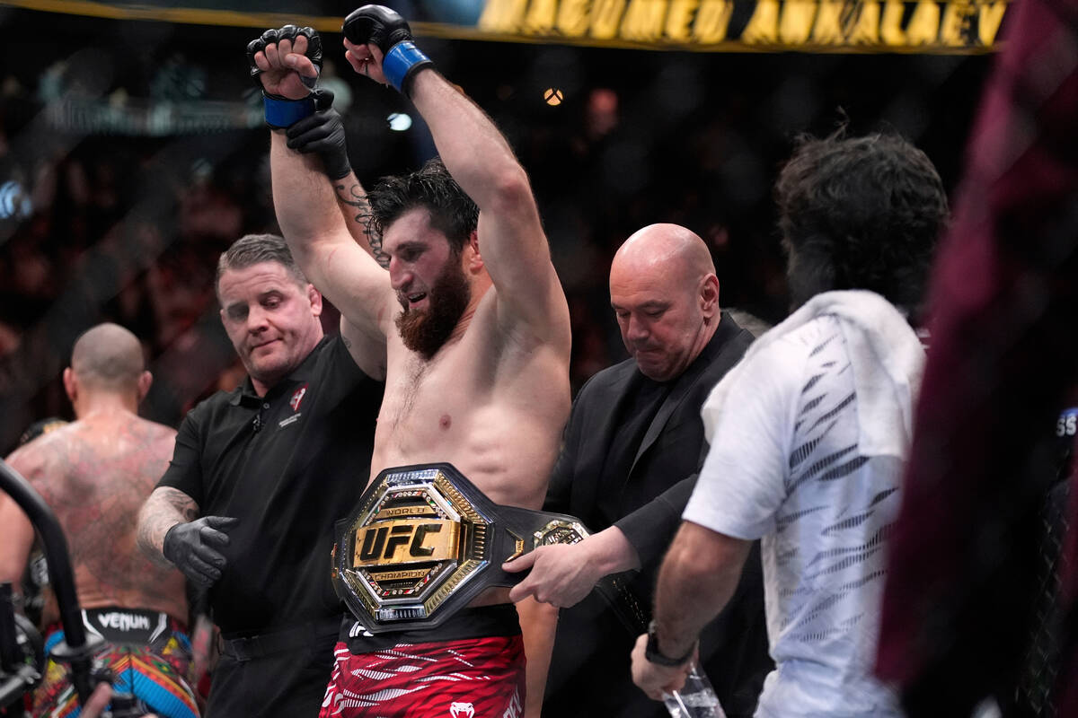 FILE - Dana White, CEO of the Ultimate Fighting Championship, puts the belt on Magomed Ankalaev ...