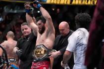 FILE - Dana White, CEO of the Ultimate Fighting Championship, puts the belt on Magomed Ankalaev ...