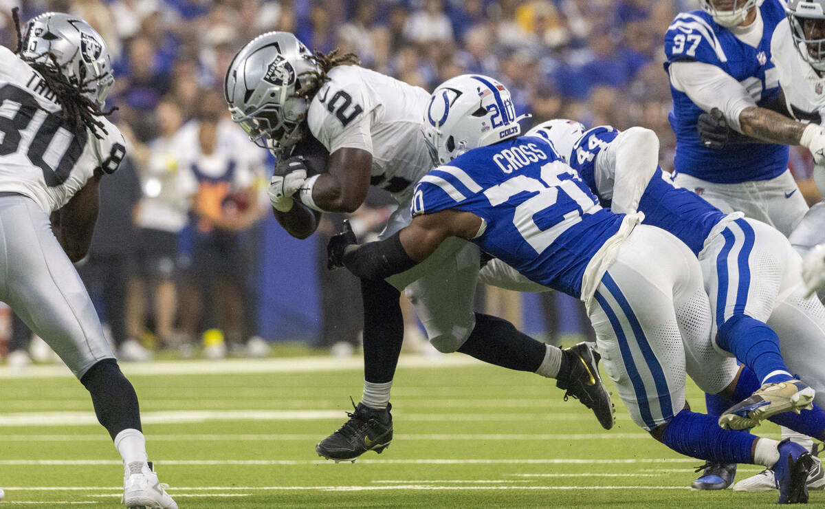 Raiders running back Ashton Jeanty (2) is tackled by Indianapolis Colts safety Nick Cross (20) ...