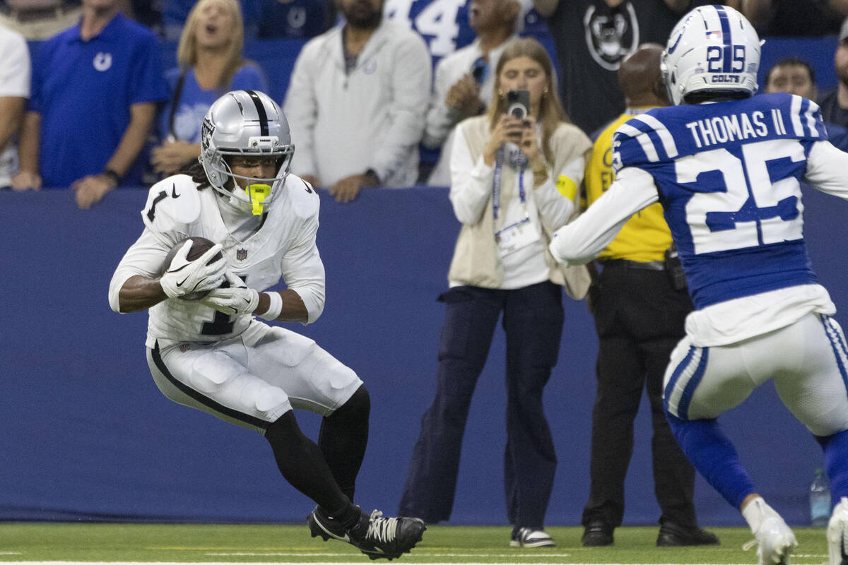 Raiders wide receiver Tre Tucker (1) looks for more yardage against Indianapolis Colts safety R ...