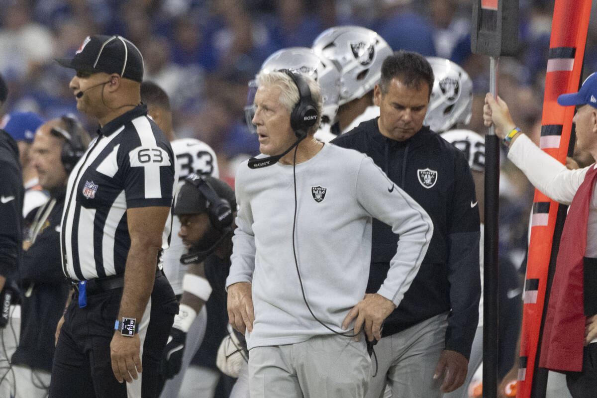Raiders head coach Pete Carroll works from the sideline during the first half of an NFL game ag ...