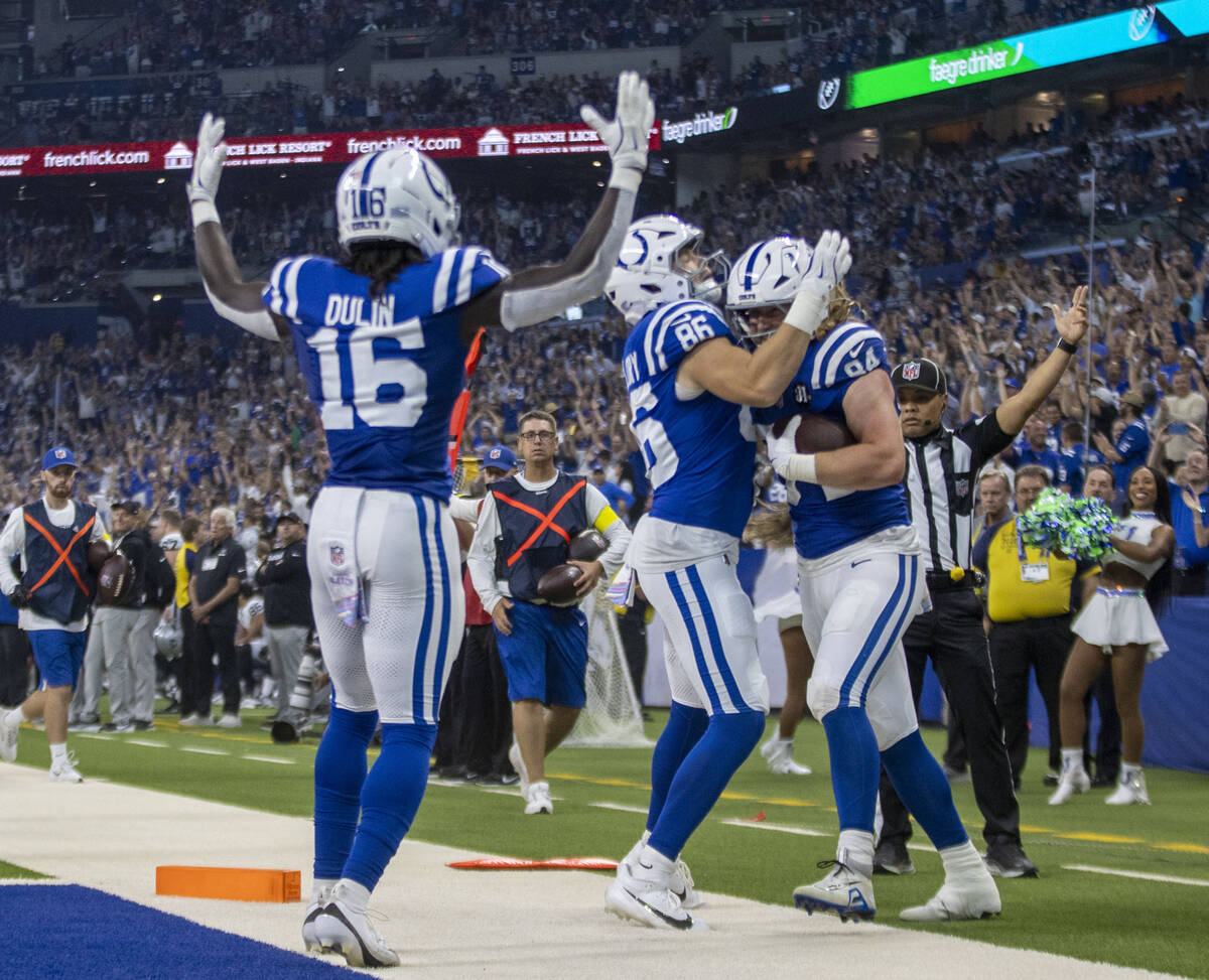 Indianapolis Colts wide receiver Ashton Dulin (16) signals for a touchdown as tight end Will Ma ...