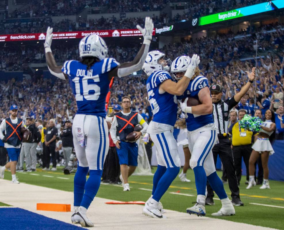 Indianapolis Colts wide receiver Ashton Dulin (16) signals for a touchdown as tight end Will Ma ...