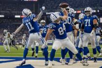 Indianapolis Colts tight end Tyler Warren (84) and wide receiver Michael Pittman (11) spike foo ...