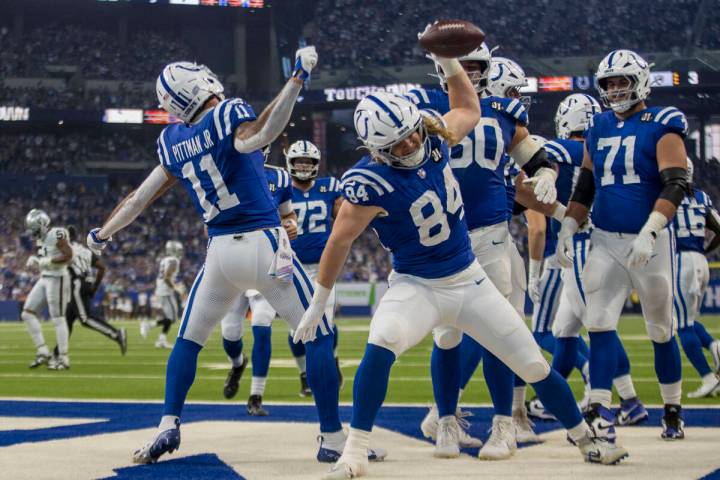 Indianapolis Colts tight end Tyler Warren (84) and wide receiver Michael Pittman (11) spike foo ...