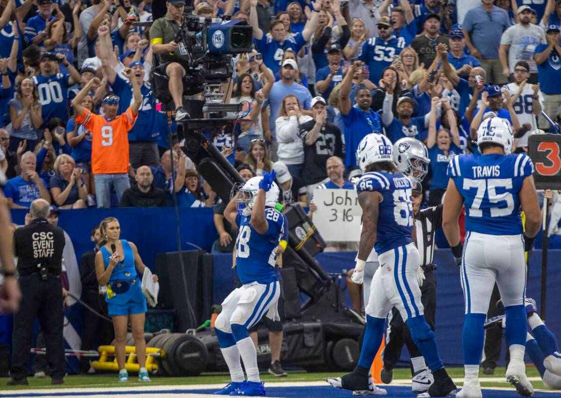 Indianapolis Colts running back Jonathan Taylor (28) celebrates a touchdown score against the R ...