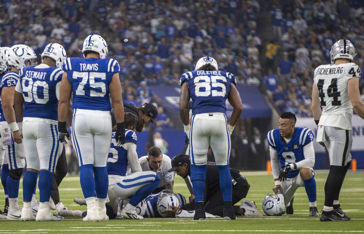 Indianapolis Colts kicker Spencer Shrader (3) remains down after being hit late by Raiders safe ...