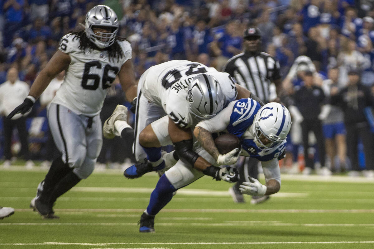 Raiders offensive tackle Stone Forsythe (70) tackles Indianapolis Colts defensive end Laiatu La ...