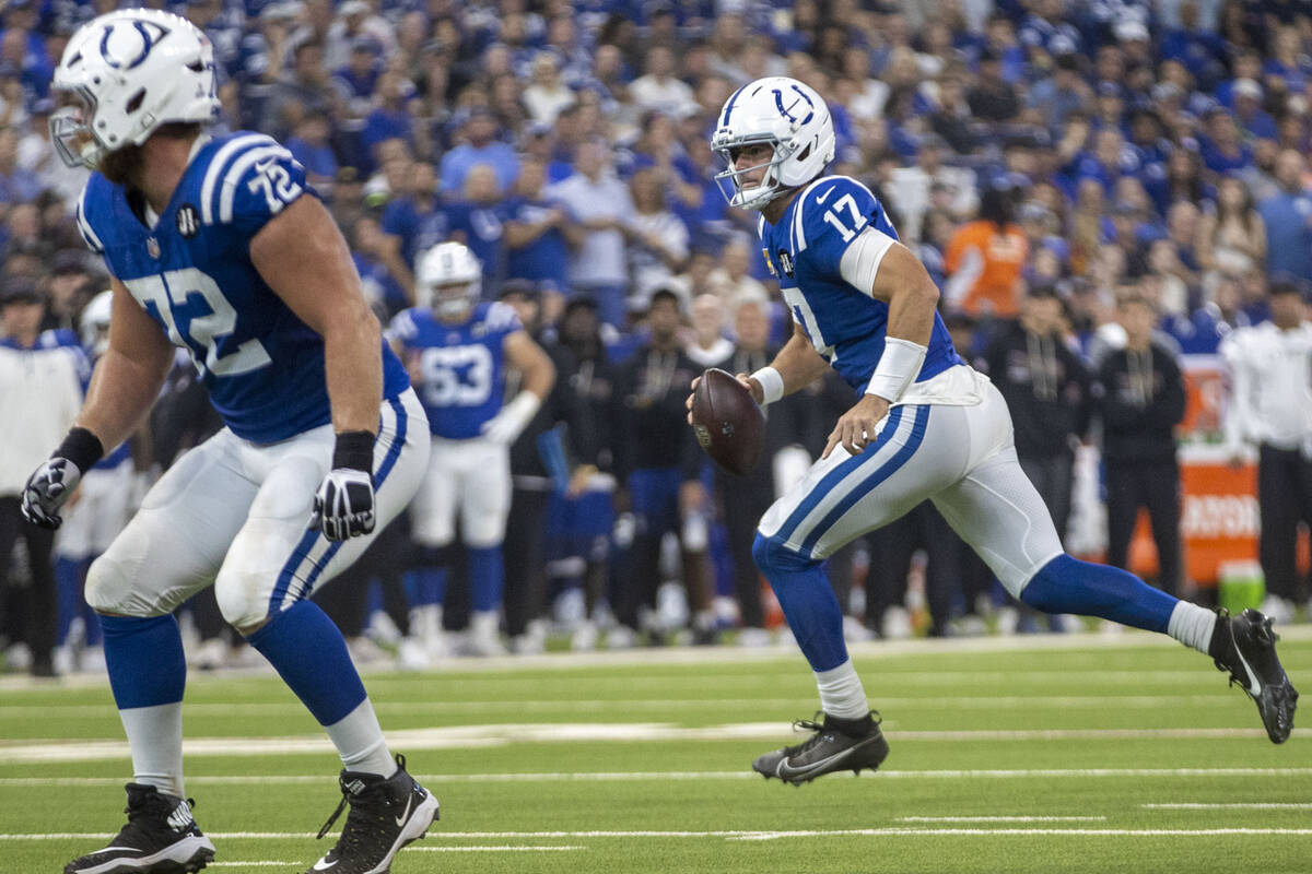 Indianapolis Colts quarterback Daniel Jones (17) scrambles against the Raiders during the firs ...