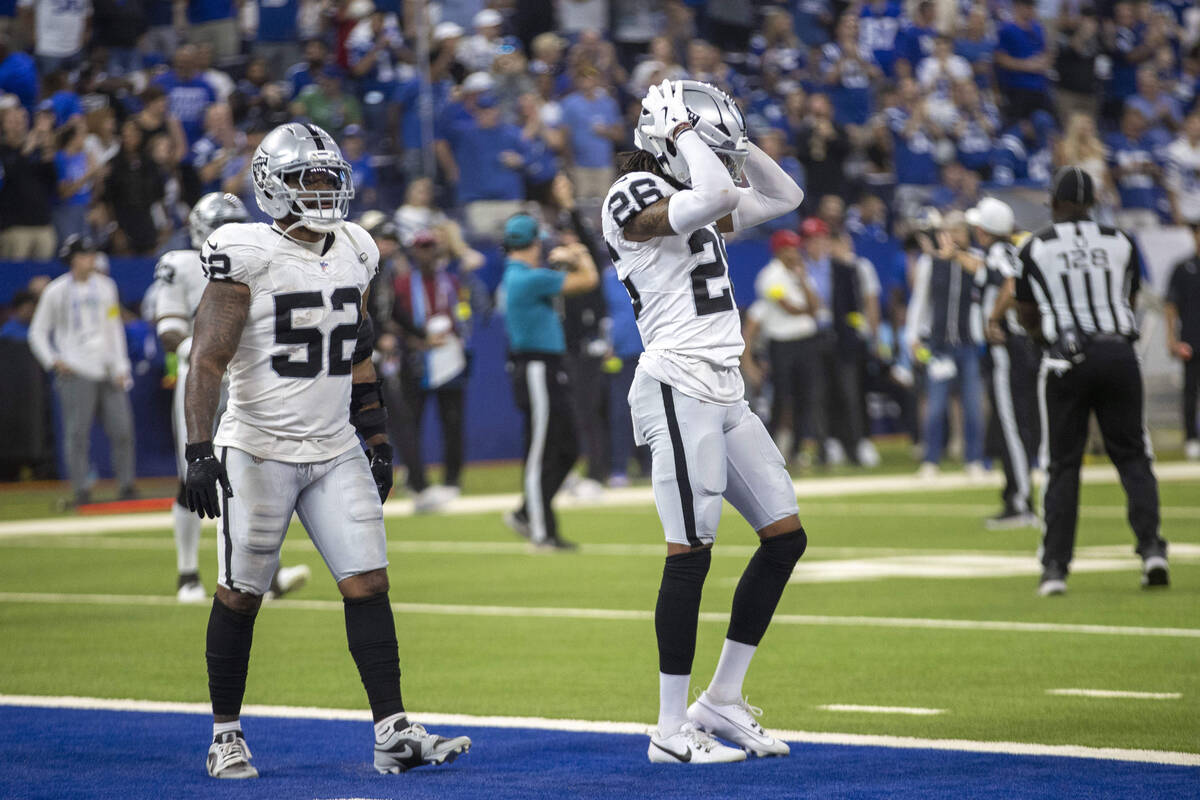 Raiders cornerback Darien Porter (26) reacts to giving up a touchdown with outside linebacker E ...