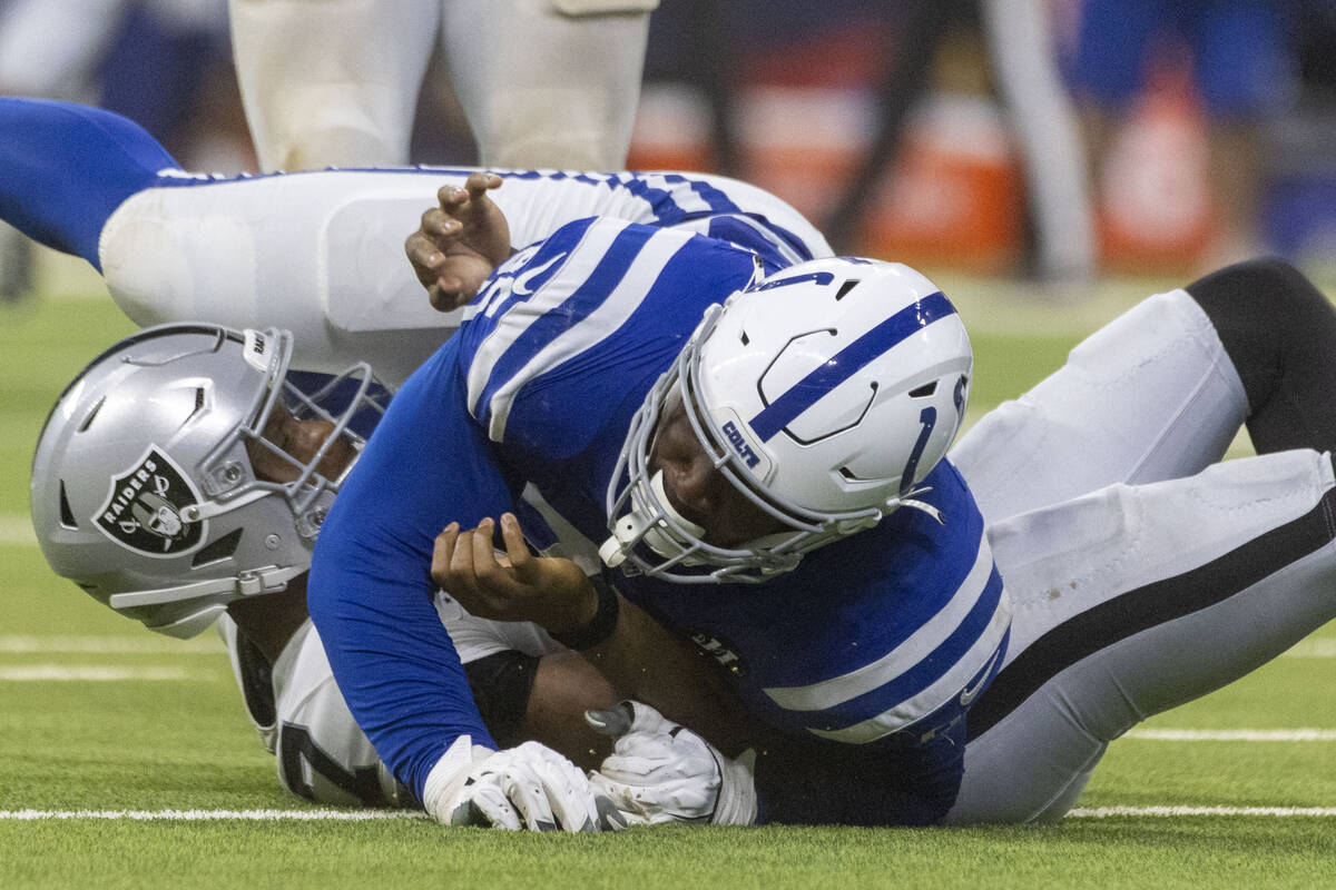 Indianapolis Colts defensive tackle Adetomiwa Adebawore (95) sacks Raiders quarterback Geno Smi ...