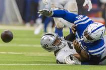 Indianapolis Colts defensive tackle Adetomiwa Adebawore (95) reaches for a loose football after ...