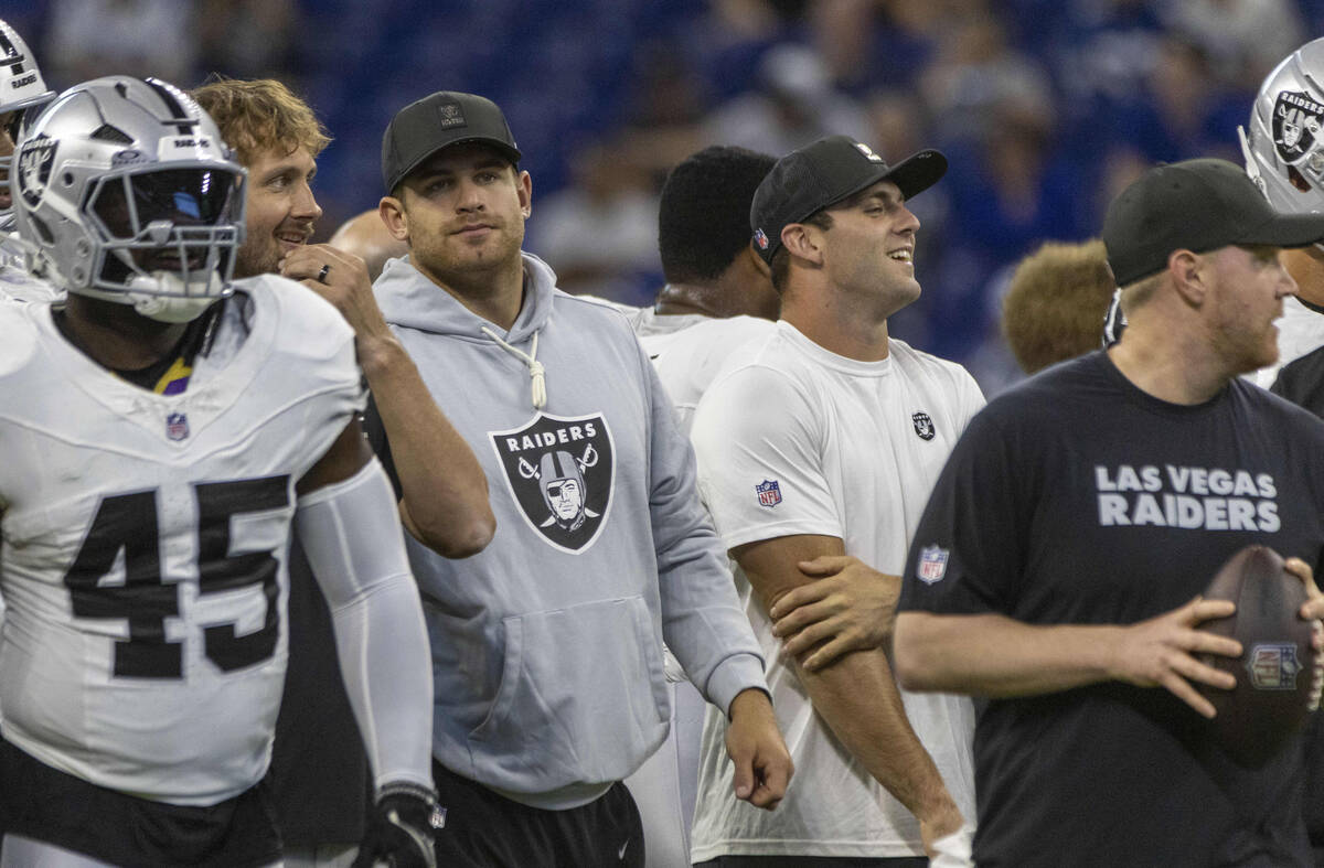 Raiders tight ends Michael Mayer, left center, and Brock Bowers, right center, watch as their t ...