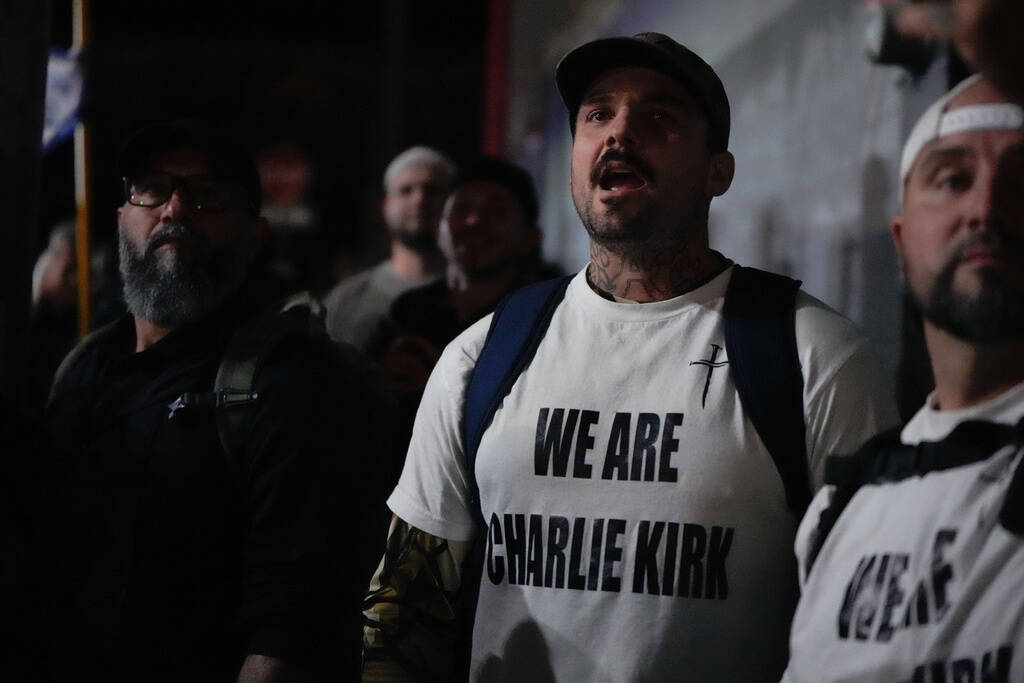 People react as tear gas is deployed on protesters outside a U.S. Immigration and Customs Enfor ...