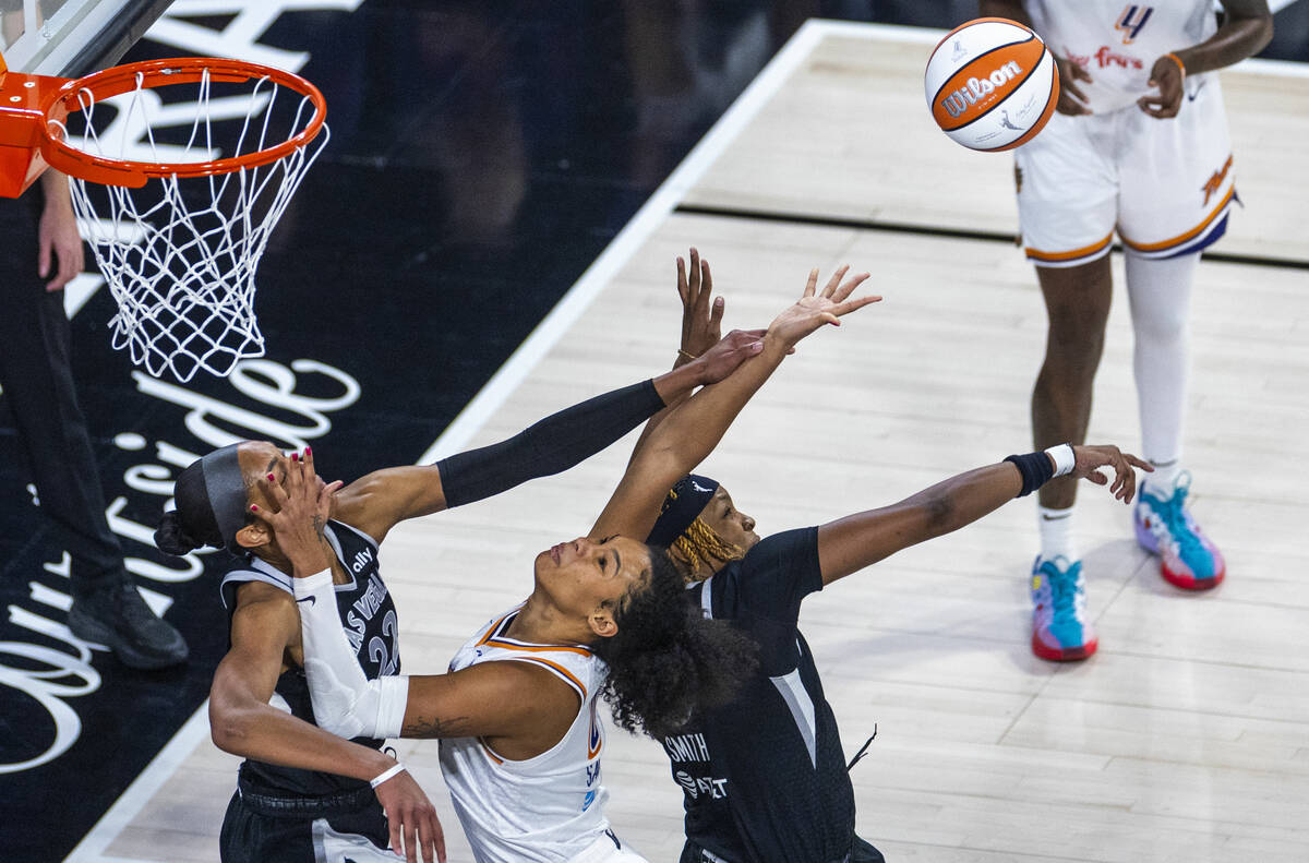 Aces center A'ja Wilson (22) deflects a loose ball away while getting a hand to the face b ...