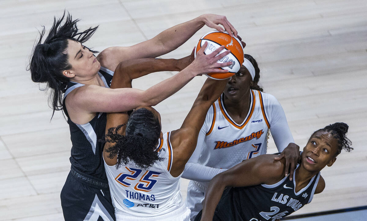 Aces center Megan Gustafson (17) battles for a loose ball with Phoenix Mercury forward Alyssa T ...