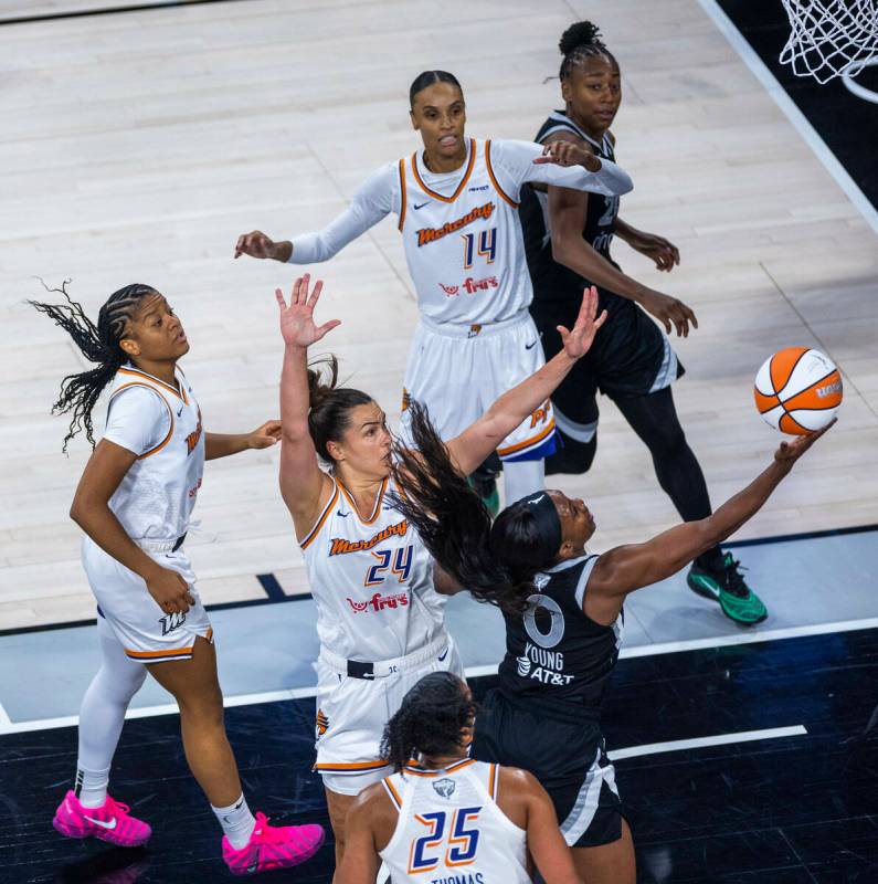 Aces guard Jackie Young (0) gets inside of Phoenix Mercury forward Kathryn Westbeld (24) for a ...
