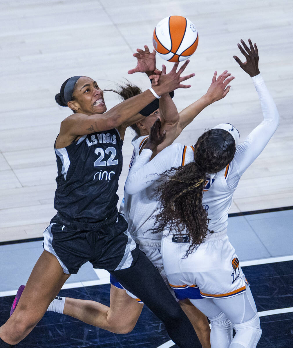 Aces center A'ja Wilson (22) battles for a loose ball with Phoenix Mercury defenders durin ...