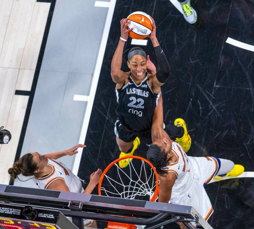 Aces center A'ja Wilson (22) posts up for a basket between Phoenix Mercury forward Kathryn ...